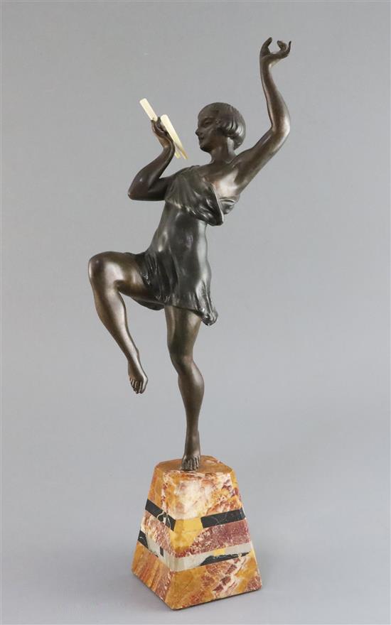 Attributed to G. Limousin. A bronzed metal and ivory figure of a pan pipe dancer, 18in.